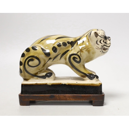 1259 - A Chinese Cizhou style pottery tiger incense stick holder on wood stand, 13cm tall