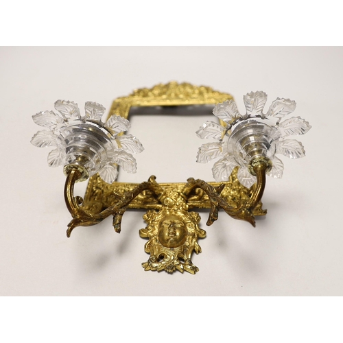 1298 - A decorative two branch ormolu wall mirror, lacking the mirror inset. 39cm tall overall, 16.5 x 11.5... 