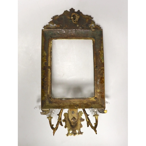 1298 - A decorative two branch ormolu wall mirror, lacking the mirror inset. 39cm tall overall, 16.5 x 11.5... 