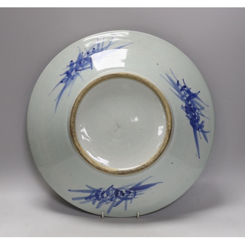 1303 - A 19th century Chinese blue and white landscape dish. 38cm diameter