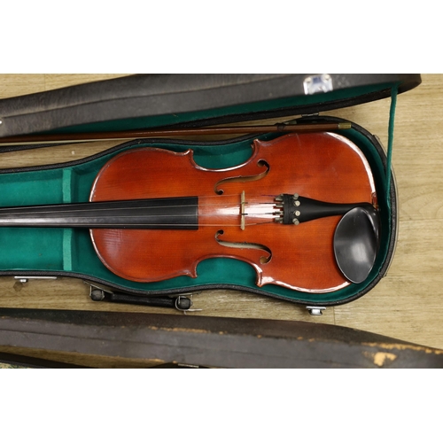 1308 - Two cased violins, one bow