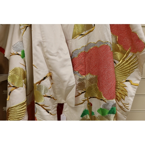 1417 - A Japanese cream ground ceremonial kimono, embroidered with coloured silks and metallic embroidery, ... 