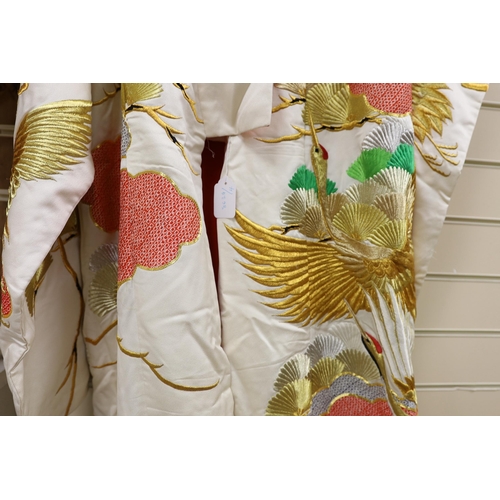 1417 - A Japanese cream ground ceremonial kimono, embroidered with coloured silks and metallic embroidery, ... 