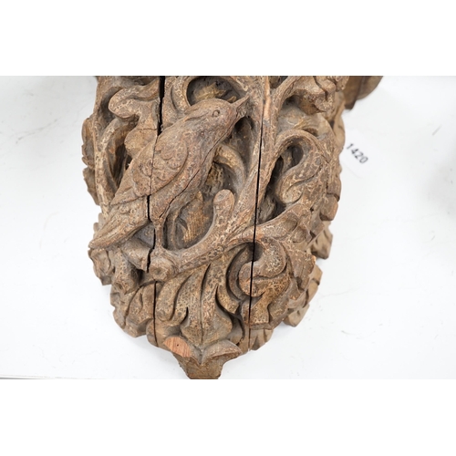 1420 - A Victorian/Edwardian carved pine wall bracket, carved with a bird within scrolling oak leaves, 36cm... 