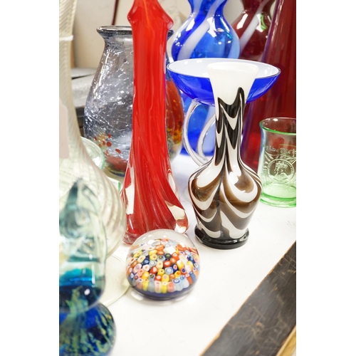 1441 - A large group of mixed art glass and other coloured glass vases, bowls, paperweights and two stopper... 