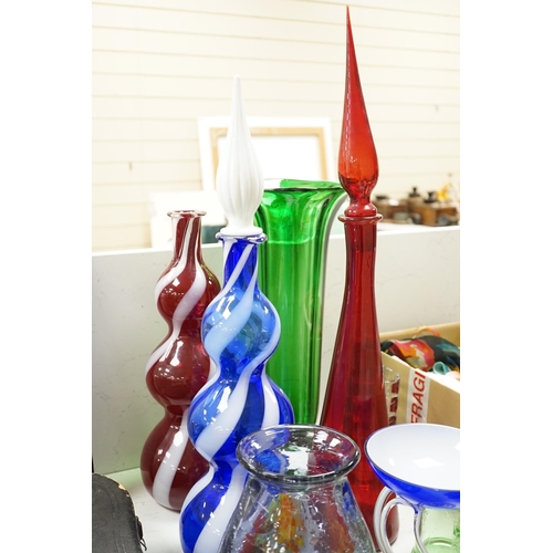 1441 - A large group of mixed art glass and other coloured glass vases, bowls, paperweights and two stopper... 