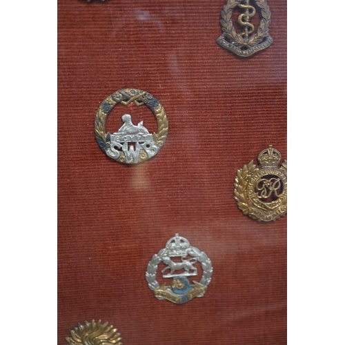 1452 - A framed collection of military cap Badges