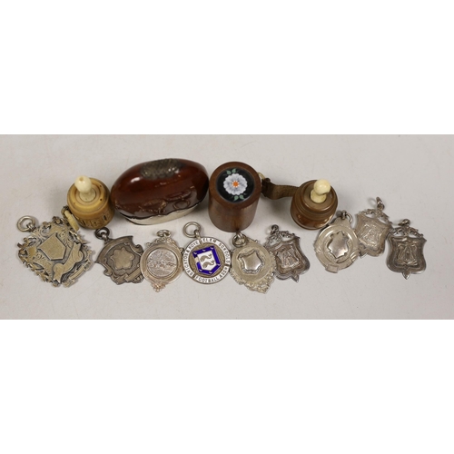 1483 - A stag. silver mounted nut vesta case, two tape measures, a small box and sundry medallions