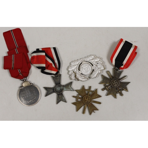 1500 - Four German Third Reich medals, comprising three merit crosses, and a Winterschlacht medal, together... 