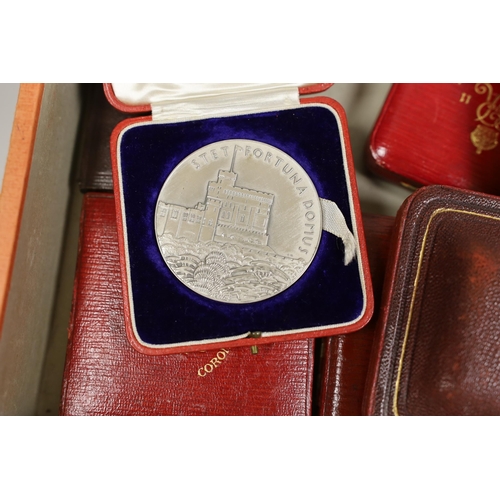 1505 - A mixed collection of British cased commemorative medallions to include a cased silver and two bronz... 