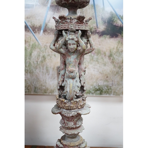 1533 - A pair French cast metal candlesticks. 47cm tall