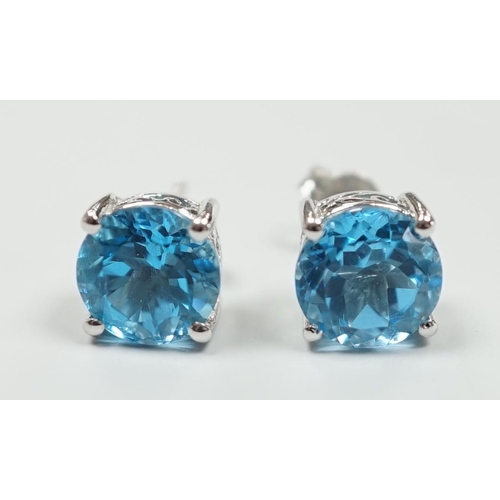 1880 - A modern pair of white metal (stamped 18) and single stone blue topaz set ear studs, 7mm, gross weig... 