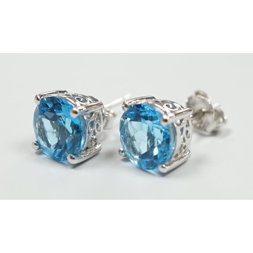 1880 - A modern pair of white metal (stamped 18) and single stone blue topaz set ear studs, 7mm, gross weig... 