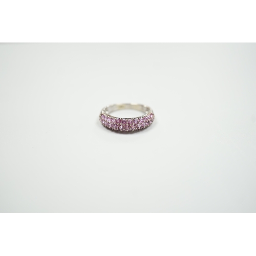 1886 - A modern 18ct white gold and pink stone cluster set half hoop ring, size J, gross weight 4.2 grams.... 