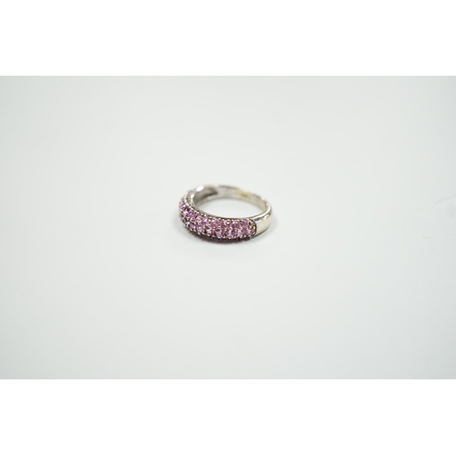 1886 - A modern 18ct white gold and pink stone cluster set half hoop ring, size J, gross weight 4.2 grams.... 