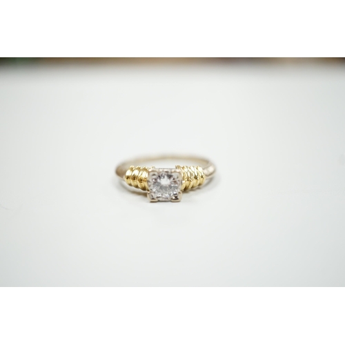 1890 - A modern 18ct two colour gold and solitaire diamond set ring, size H/I, gross weight 3.3 grams.... 