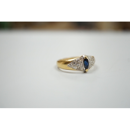 1895 - A modern 18ct gold and single stone marquise cut sapphire set dress ring, with pave set diamond shou... 