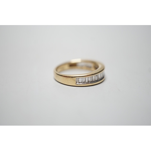 1915 - A modern 14k yellow metal and graduated  baguette and trapeze cut diamond set half eternity ring, si... 