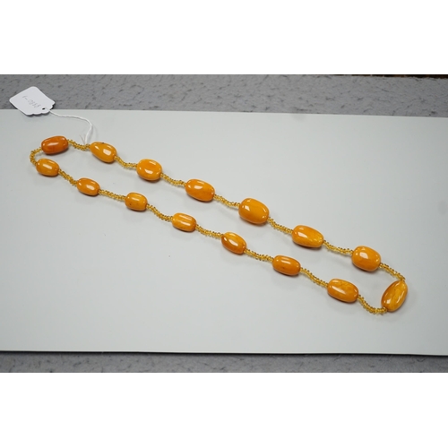 1926 - A single strand graduated fifteen amber bead necklace, with multiple amber? spacers, 84cm, gross wei... 