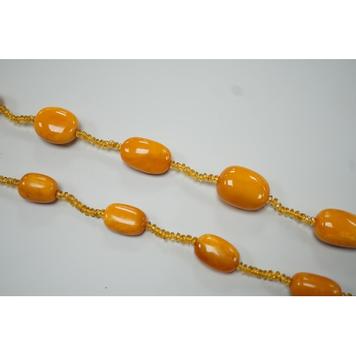 1926 - A single strand graduated fifteen amber bead necklace, with multiple amber? spacers, 84cm, gross wei... 