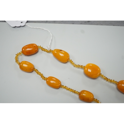 1926 - A single strand graduated fifteen amber bead necklace, with multiple amber? spacers, 84cm, gross wei... 