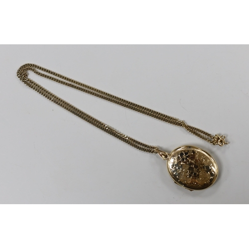 1928 - A modern 9ct gold oval locket, 33mm, on a 9ct gold chain, gross weight 16 grams.