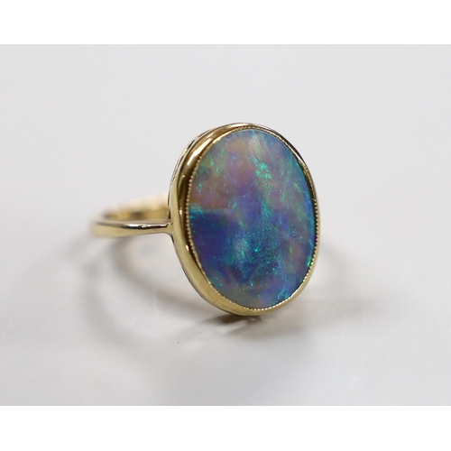 1935 - A 9ct and oval black opal set ring, size O, gross weight 4.3 grams.