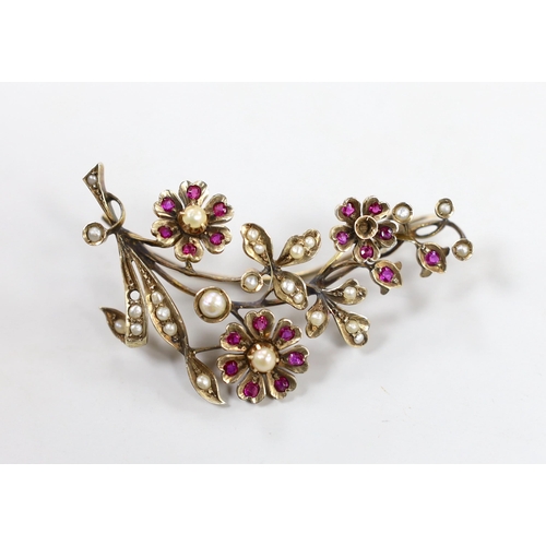 1944 - An early to mid 20th century, yellow metal, ruby and seed pearl cluster set floral spray brooch, 55m... 