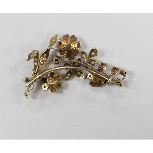 1944 - An early to mid 20th century, yellow metal, ruby and seed pearl cluster set floral spray brooch, 55m... 