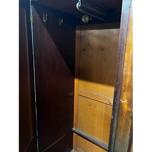 136 - A late 18th century mahogany compactum wardrobe, fitted with three flame mahogany doors, length 217c... 