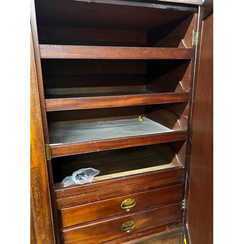 136 - A late 18th century mahogany compactum wardrobe, fitted with three flame mahogany doors, length 217c... 