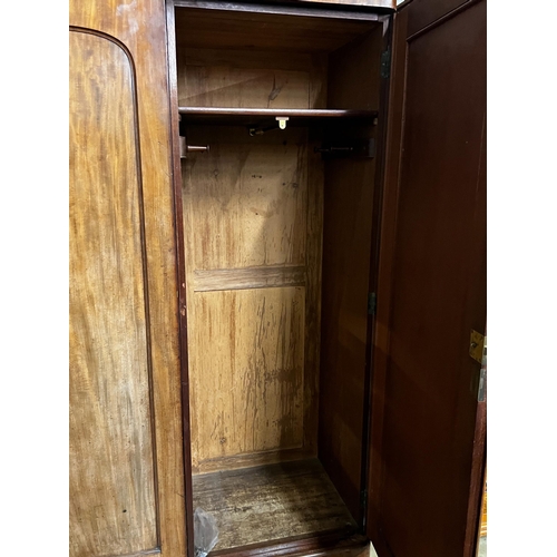 141 - A Victorian mahogany wardrobe, enclosed by a pair of arched panelled full length doors, width 132cm,... 