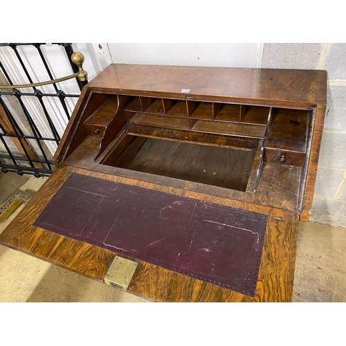 143 - An 18th century walnut veneered bureau, adapted, fitted four graduating long drawers, width 97cm, de... 