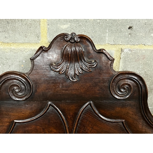 149 - A Portuguese carved oak and fruitwood settle