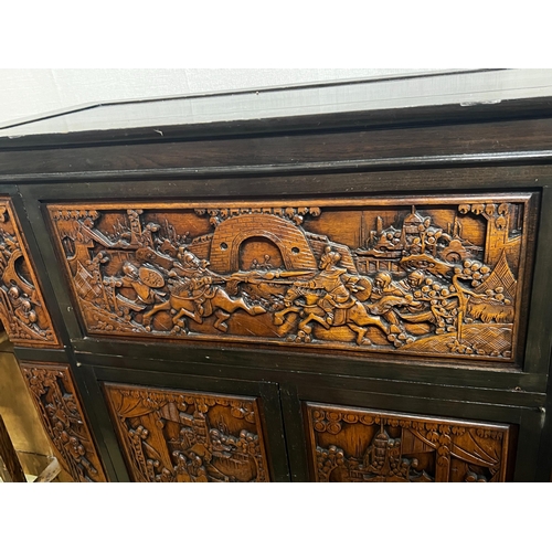 2 - A Chinese carved hinged top cocktail cabinet with mirrored interior, width 111cm, depth 46cm, height... 