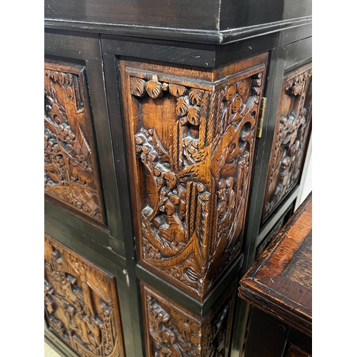 2 - A Chinese carved hinged top cocktail cabinet with mirrored interior, width 111cm, depth 46cm, height... 