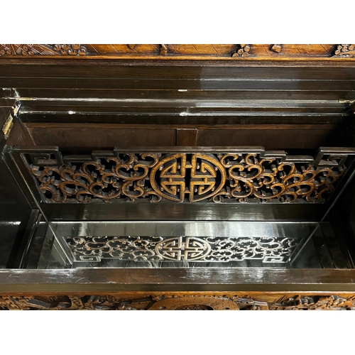 2 - A Chinese carved hinged top cocktail cabinet with mirrored interior, width 111cm, depth 46cm, height... 