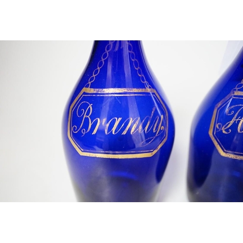 254 - A pair of Regency blue glass decanters, labelled in gilt; Brandy and Hollands, 19cms high not includ... 