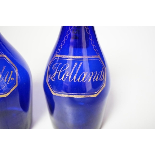 254 - A pair of Regency blue glass decanters, labelled in gilt; Brandy and Hollands, 19cms high not includ... 