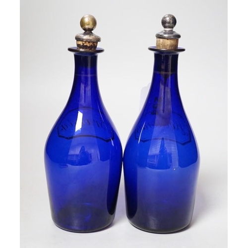 254 - A pair of Regency blue glass decanters, labelled in gilt; Brandy and Hollands, 19cms high not includ... 