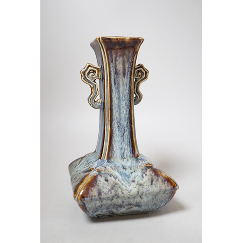 256 - A Chinese Shiwan two handled vase, 23cms high