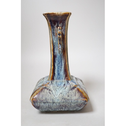 256 - A Chinese Shiwan two handled vase, 23cms high