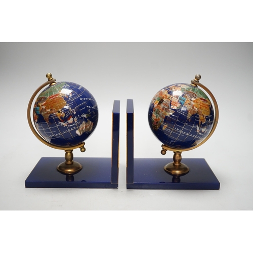 264 - A pair of hardstone mounted acrylic terrestrial globe bookends. 18cm tall