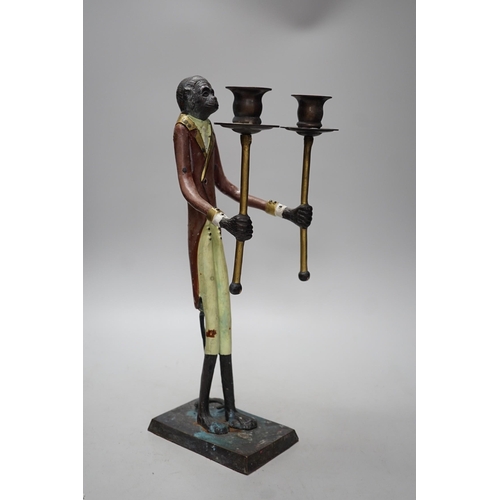 273 - A painted iron novelty two branch monkey candlestick, 44cms high