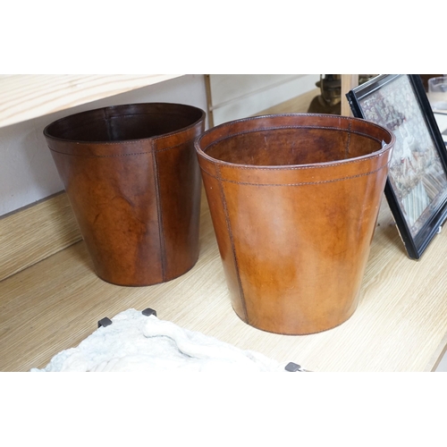 277 - Two brown leather waste paper bins, 30cms high,