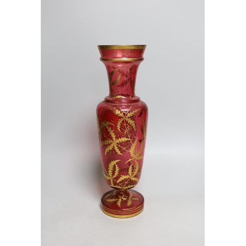 326 - A 19th century Bohemian overlaid cranberry glass vase, 37cm tall