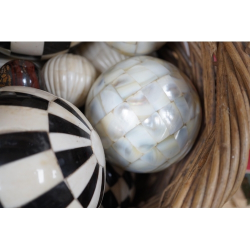 379 - A basket of mother of pearl or bone veneered balls and other decorative balls