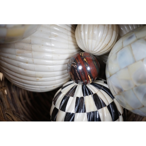 379 - A basket of mother of pearl or bone veneered balls and other decorative balls