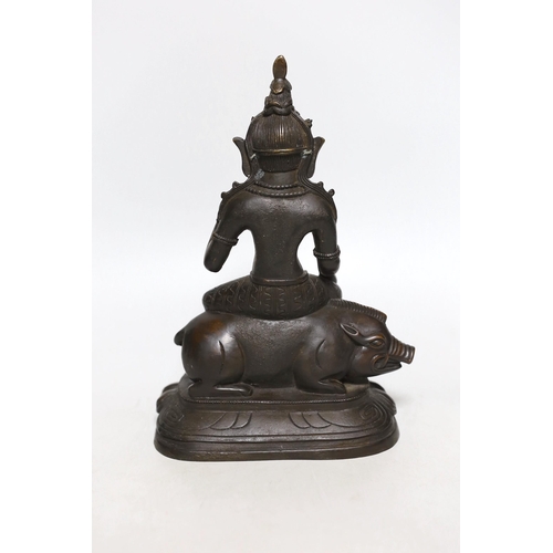 395 - A buddhist bronze figure of Marici seated on a boar, 26cms high