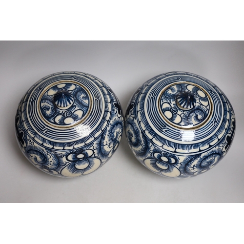 414 - A pair of Chinese blue and white Shuangxi jars and cover, 25cms high